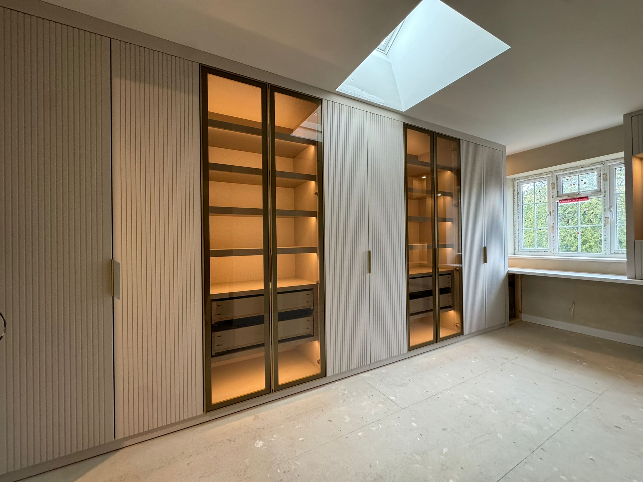 Modern wardrobe with light up shelving and glass doors
