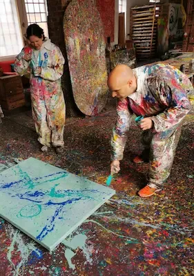 Action painting session showcasing vibrant creativity. Action painting session showcasing vibrant creativity.