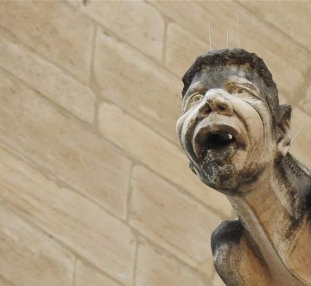 Ahmed Benzizine-like gargoyle is adorned with the double inscription “Dieu est grand” and « الله أَكْبَر » (Allahu akbar).