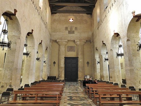 The interior of the Duomo. Two ancient Doric columns are visible on both sides of the entrance.