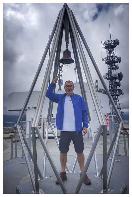 Rinking the Bell of Happiness atop the summit observation deck of Mount Moiwa.