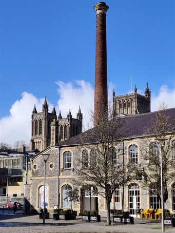 Bristol Cathedral behind a redeveloped old barbor building next to Millenium Square.