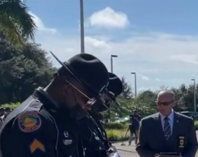 PRAYING AT FUNERAL OF FALLEN HERO