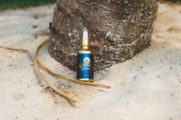 Light Mandalas AquaAurum elixir placed in nature for purity and rejuvenation.