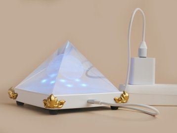 Light Mandalas Resonator connected to power, emitting blue light for energy harmonization.