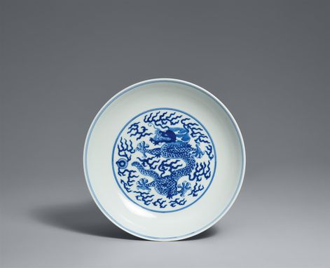 A blue and white dragon saucer shaped dish.
