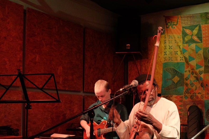 Luka -Mozambique- Xitende; Jordan -Australia -Guitar; Daniel -Colombia - Trombone , playing Xabonga Nkuluwamunhu, a composition of Luka.