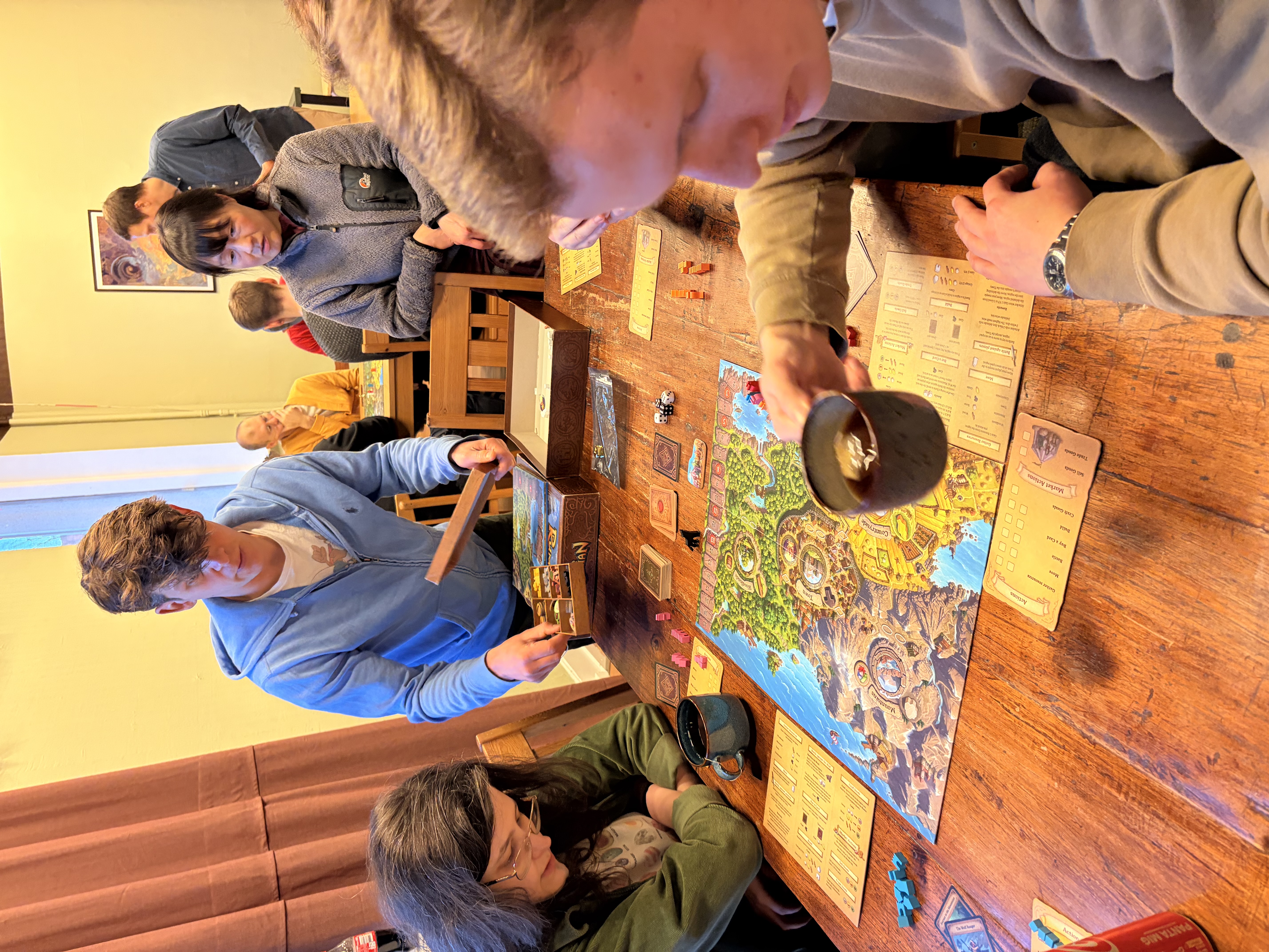Players learning a board game at Mythos in Mölndal
