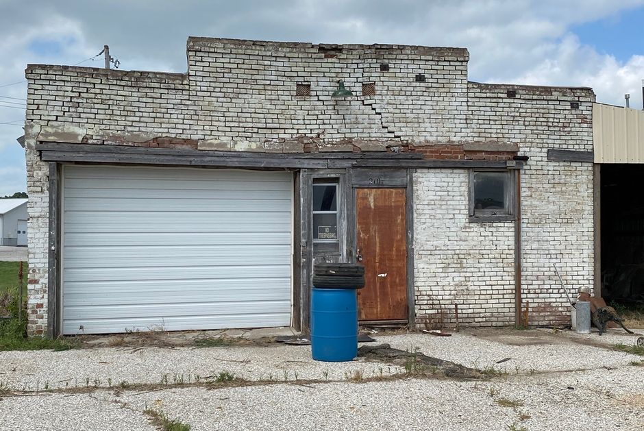 The brick building to the west was where part of the Canning Company was located.  In a couple pictures back you can see the building was a 