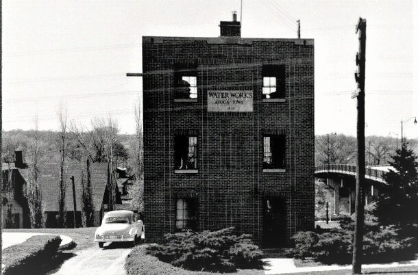 This is a photo from an early Avoca postcard showing the Avoca Water Works building near the old viaduct on Highway 59.  A neat thing about this photo is that the old Avoca Depot can be made out in the far left of the photo.  The old car in the photograph is a two-toned green 1949 Chevy that belonged to Lawrence Kelgard who worked at the Water Works plant.  John Butcher helped build the addition to the Water Works plant in 1963, so this photo was before 1963.  Kelgard was still working at the plant in 1963 when the addition was being built.