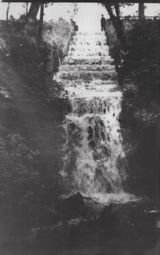 M74 Waterfall flowing from lower pond, Graves Park. Keeper standing on