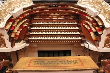 Two methods used by organ builders to expand the tonal possibilities of a pipe organ without increasing the number of pipes are borrowing and unification.
The photo shows the horseshoe console of the 4 manual, 36 rank Wurlitzer theatre pipe organ in the Fox Theatre, St. Louis, Missouri, an instrument with 348 stop tablets.
Historically, an organ like this with 36 individual ranks of pipes can be expected to have no more than 36 independent stops, with each rank playable only from its own division and manual.
With the application of electricity to organ building in the late 19th century, it became possible to electrically couple certain ranks of pipes located in one chamber with another, thus making it possible for those same voices to be playable from more than one manual at the same time, a process called 