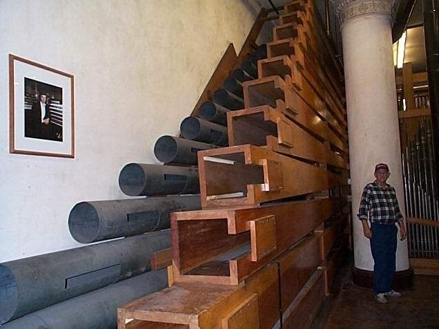 Sometimes the lowest octave of a rank of pipes in the organ, which is normally fixed in a vertical position on the windchest, is mounted horizontally, the pipes stacked one upon another, to make the most use of the available space.
Photo shows the 32 foot Contra Gamba (metal) and 32 foot Contra Diaphone (wood) of the String Pedal division of the Wanamaker Grand Court organ, Philadelphia, PA, the largest fully functional pipe organ in the world.