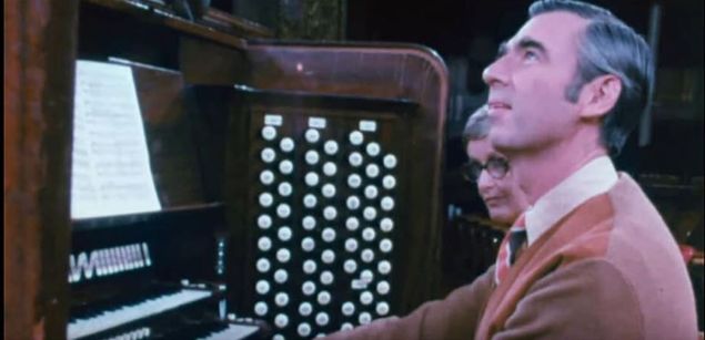 That look.
It says it all.
This is puppeteer, actor, Presbyterian minister, pianist, and gifted song-writer Mr. Fred Rogers, of Mr. Roger's Neighborhood on PBS television, seated at the 1917 IV/108 Skinner organ of Carnegie Music Hall in Pittsburgh, Pennsylvania, an instrument rebuilt by Aeolian-Skinner in 1933.
Not many are fully aware of what a fine musician Mr. Rogers happened to be; besides writing all the basic music for his television show he also graduated magna cum laude from Rollins College in 1951 with a bachelor's degree in music composition, was an accomplished performer at the piano, and could play the organ casually because of his piano training.
His expression captures what organists have felt from the first moment they had in their command a really large pipe organ and first heard its glorious voice respond to their own fingers and feet and mind.
That experience does something to the new organist that's hard to describe ...
This is the most gorgeous musical instrument to the ears of organists in existence; the beauty of its voices, its tremendous pitch and dynamic spectra which exceeds that of the grand symphony orchestra and sounds like a symphony of players, its incredible ability to express the entire range of human emotion at the touch of a key, its awesome capacity to affect its listeners at a raw, visceral level, and its sheer, thrilling power transports them to a different realm ... to the place where creation has its home ... to a place of unlimited scope where, for a little while, they're in touch with their own soul in another dimension and in perfect union, able to hear only the sounds of the music, virtually unaware of anything else going on around them.
Hearing the inspired music written by composers for this wonder of an instrument gives organists a glimpse of another world ... a kingdom of LIght filled with power, love, and purpose ... three things our own broken world desperately needs. 
This is as 