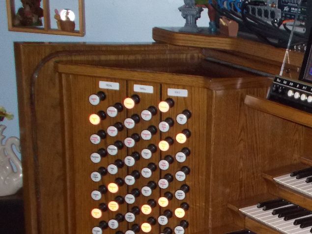(con't from Part II)
The Duet virtual theatre pipe organ (VTPO) unit manufactured by MIDI Concepts LLC (photo) during the 1990's and early 2000's required only one or more MIDIfied keyboards and a speaker system for playability; a host console's manuals and speaker system could also be employed for this purpose, provided that it was able to send MIDI information to Duet.
Duet consisted of 1) a sound generator box, 2) a memory stick (USB thumb drive) which stored all of its voices, couplers, controls, and MIDI-configuration for the host instrument, and 3) a touch-sensitive control panel provided with 2-phase LED lighting.
These three components communicated with the host instrument via a MIDI cable and with the external speaker system by means of an audio cable.
Production of this VTPO was limited -- only about 200 made it into circulation -- and very few remain in working condition, but if and when organists may encounter one they will find themselves in for a treat.
This was a serious piece of equipment which could be used with any MIDIfied host instrument including electronic organs, pipe organs, or keyboard rack systems -- a complete III/24 unit theatre organ which offers ranks sampled from Wurtlizer, Barton, Kimball, and Page theatre organs, 208 possible stops, and Great and Accompaniment Double Touch stops for those manuals supplied with this feature.
Its memory stick also could be configured for any MIDI-capable digital piano without pedals (in which case the Accompaniment and Pedal voices would play below the split point and either the Great or Solo voices would play above the split point depending upon the position of the Solo/Great (S/G) flip switch on the lighted control panel.
Adding or subtracting a single stop, coupler, modifier, or changing the memory level with this unit could be done 