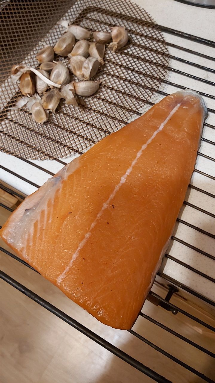 Salmon smoked along with black garlic cloves