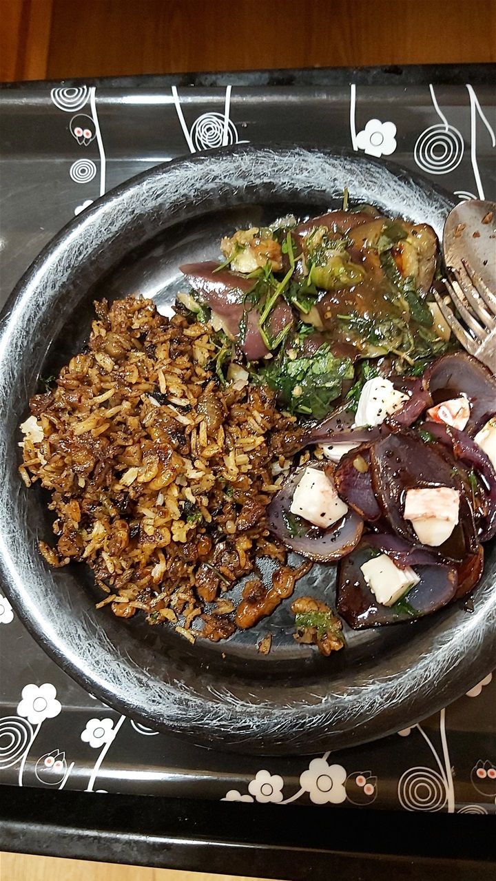 Ottolenghi's dirty rice, aubergine with herb and crispy garlic as well as sweet and sour onion petals with goat's cheese
