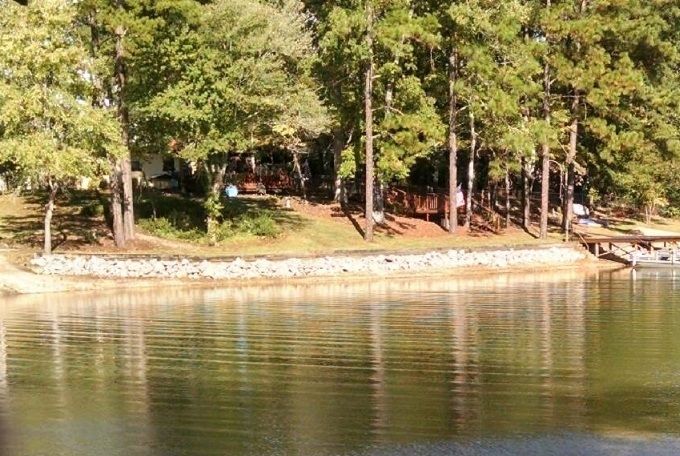 This tranquil scene of the still waters of a slough on Lake Martin, just down the Weldon Road and behind the current home of Leroy and Betty Coker does not divulge the tragic drownings that occurred almost right on this spot on June 23rd, 1932.  On this pleasant Saturday in late June, Bernard Walls and his new bride of 3 weeks, Floree Betts Walls were wading in this slough along with Alma Walls, the sister of Bernard, and Loree Betts, the sister of Floree Betts Walls.  Loree was the only one that did not know how to swim.  She stepped into an unseen underwater ditch and went in over her head.  The other three began to try to rescue her until one after the other they all drowned.  There were others standing on the bank of the slough watching but could not swim and consequently watched in horror as 4 people lost their lives drowning in Lake Martin.  The Walls family and the Betts family, as a result, each lost 2 of their children.