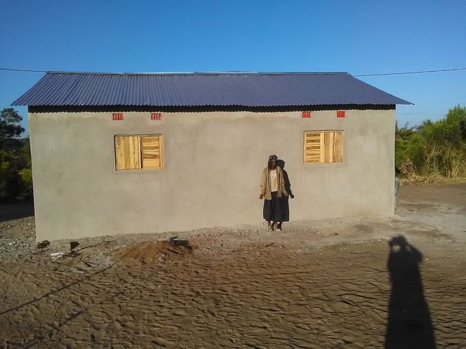 Mrs Margaret in her completed new house.