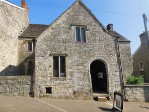 Facade of the stone building with windows and doorway