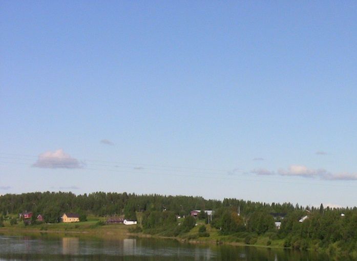 Kairalan kylämaisemaa Kitisenjoen itäpuolella. Vaaramaisemat: oikealla Tallavaara ja vasemmalla Ylivaara. Kuvattuna Kairalan sillalta.  Kuva: Tapio Tallavaara v. 2013.