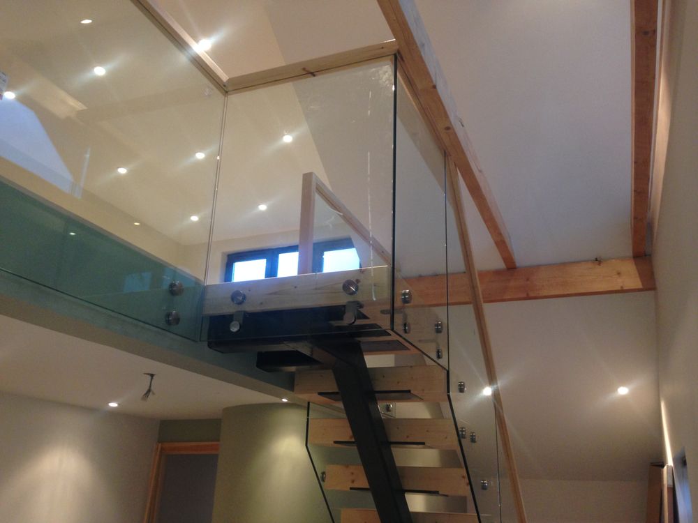 Mezzanine with glass balustrade and open-tread staircase