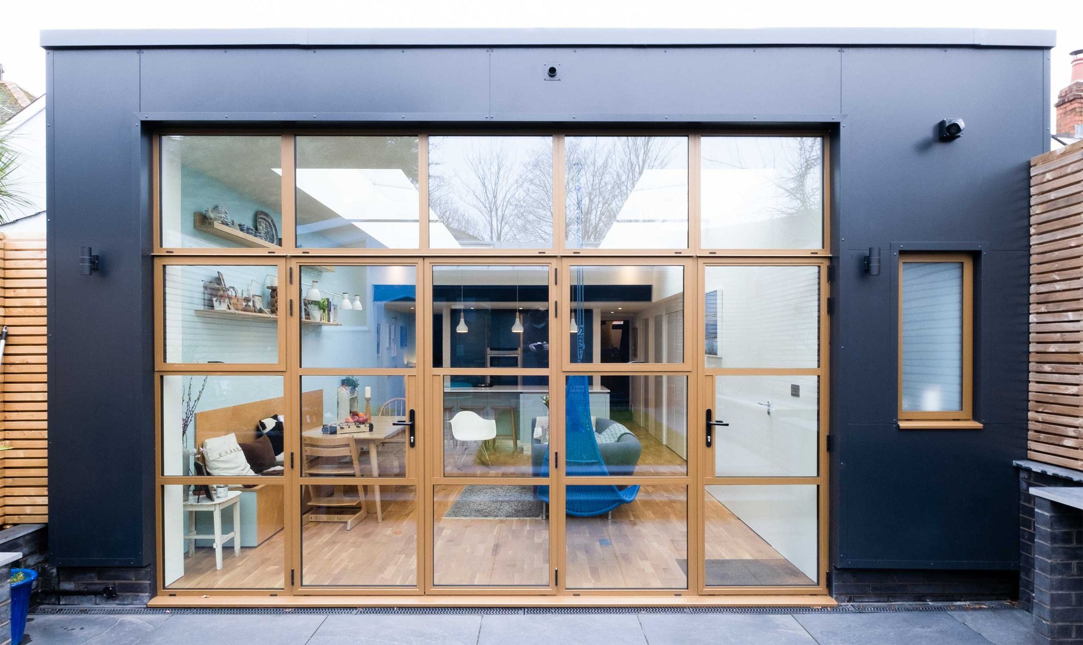 Contemporary rear extension with dark cladding and full-height oak-framed glazing