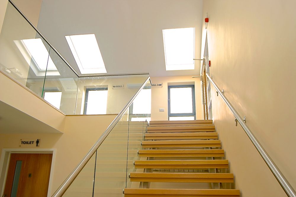 New staircase with glass balustrade and rooflights