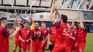 Captain Nick raising the trophy