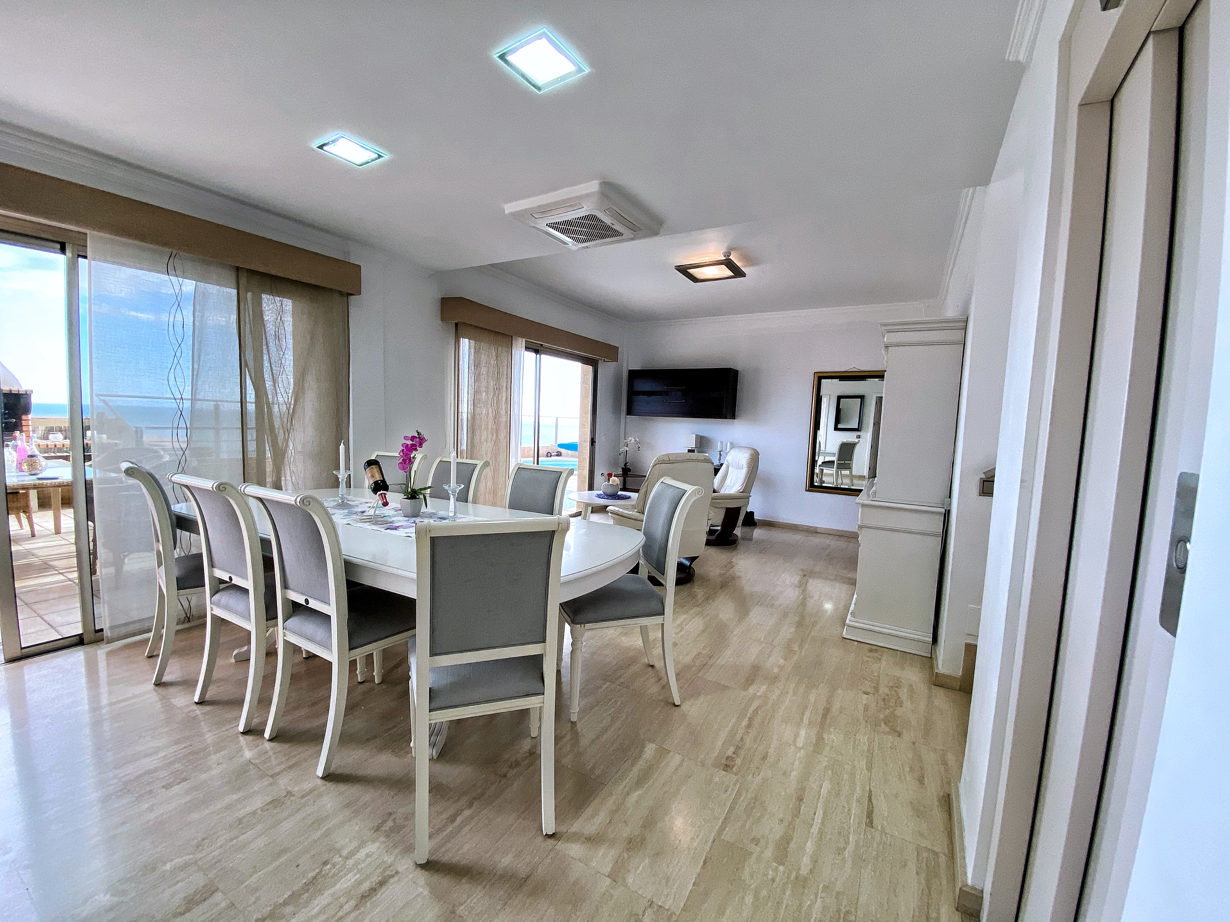 The large dining room table has ten chairs.