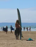 MC 19 031 - surfer suntan sand North Devon - a-woman-holding-a-surfboa