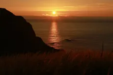 MC 19 032 - Gunwalloe church cove  sunset - a-sunset-over-the-ocean-wi