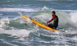 MC 19 038 - Lifeguard on his break - a-man-riding-a-surf-board-on-a-wa