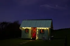 MC 19 051 - tiny home - a-small-house-with-a-green-tin-roof