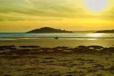 MC 19 070 - Bur Island, Devon - a-beach-with-a-sunset-and-a-person-wal