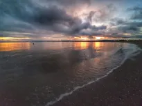 MC 20 094 Exmouth beach - a-beach-with-a-cloudy-sky-and-a-body-of-wate