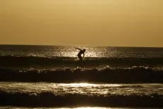 MC 20 101 - a-person-riding-a-wave-on-a-surfboard