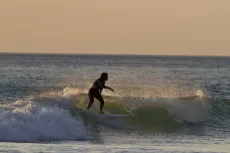MC 20 102 - a-person-riding-a-wave-on-a-surfboard