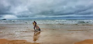 MC 21 137 - Lone surfer fistral Newquay - a-person-walking-on-the-beac