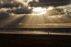 MC 21 138 - Saunton sands - a-couple-walking-on-a-beach-under-a-cloudy