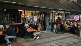 MC 25 458 - London  - a-group-of-people-sitting-at-tables-outside-a-re