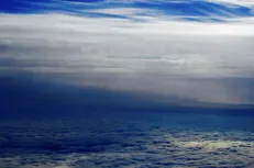  Between clouds with sun rays breaking through 