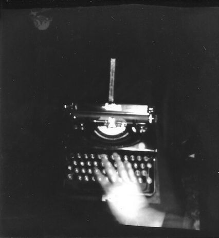 Typewriter and hand.